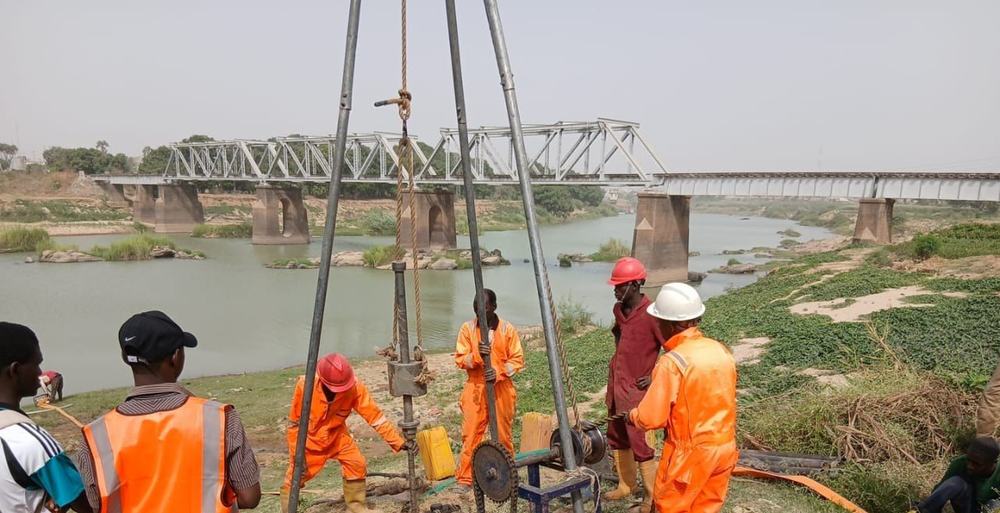 Cable percussion boring beside a river bridge in Kaduna