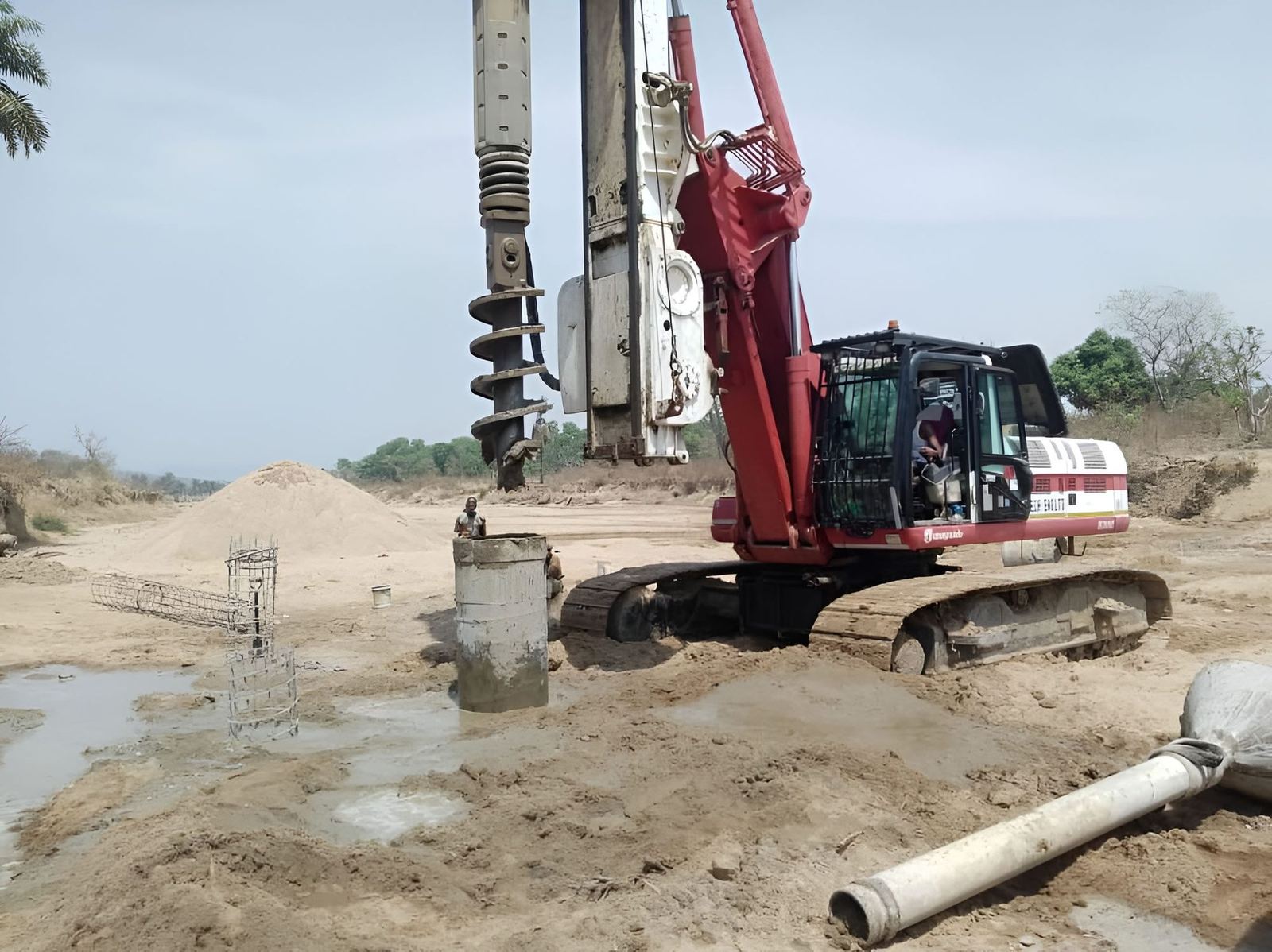 Rotary piling rig installing a bored pile